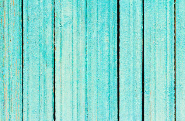 An old wooden wall with cracks and cracked turquoise paint. - Photo, Image