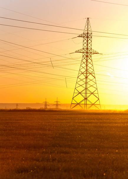 High-voltage power transmission line. Energy pillars. At sunset, - Photo, Image
