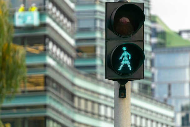 Green pedestrian signal to go. Traffic light female figure shape in Vilnius, Lithuania - Photo, Image
