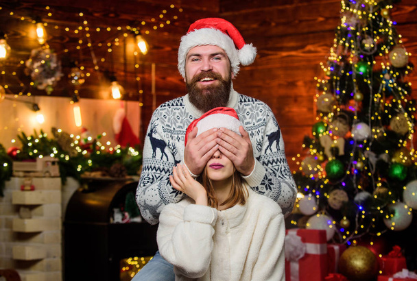 Christmas is time for giving. Couple in love enjoy christmas holiday celebration. Happy new year. Guess who. Festive spirit. Lovely married couple cuddle christmas tree background. Cheerful mood - Photo, Image
