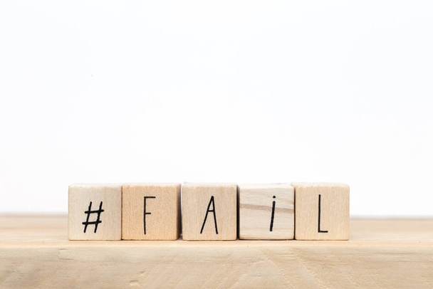 wooden cubes with a hashtag and the word fail near white background, social media design - Photo, image