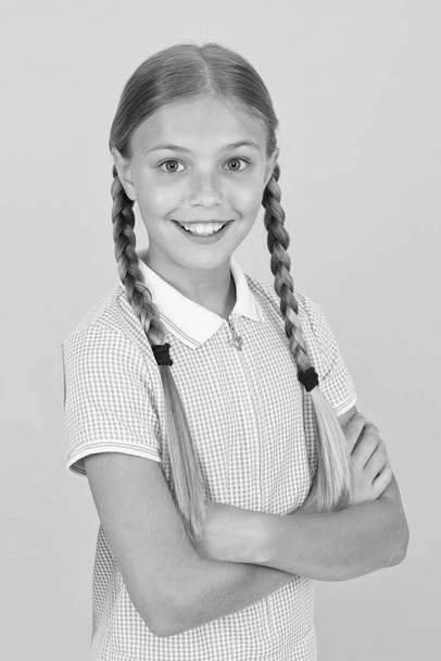 be fashionable. small girl retro uniform. old school fashion. back to school. happy beauty on yellow background. happy childhood. hair health concept. girl with long hair. smart girl in vintage dress - Foto, Imagem