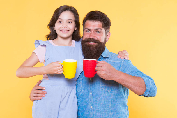 Tea for two. Happy family enjoy drinking tea together. Small daughter and father hold tea cups. Morning drink. Breakfast time. Happiness is cup of tea - Φωτογραφία, εικόνα