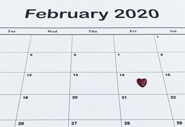 Calendar page with red heart on February 14 of Saint Valentines day. Happy Valentines Day concept. - Fotografie, Obrázek