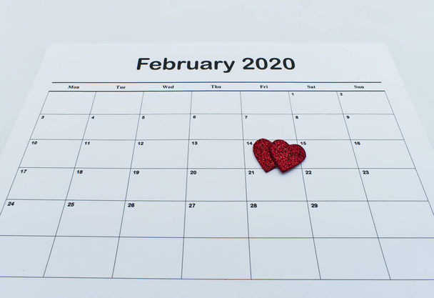 Calendar page with red heart on February 14 of Saint Valentines day. Happy Valentines Day concept. - Foto, Bild