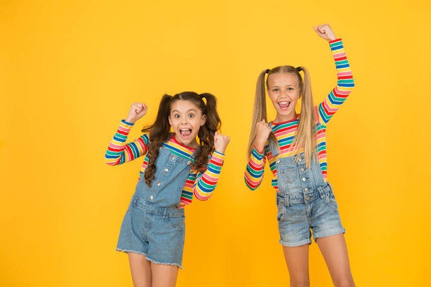 got great style. small sisters have fun. little girls yellow background. hairdresser salon. kid summer fashion. beauty and style. childhood happiness. happy school friendship. best friends forever - Zdjęcie, obraz