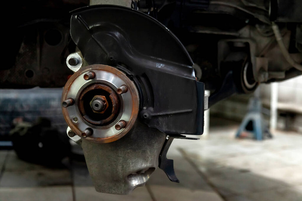 A close-up on the front brake system of a car with hub on a lift - Photo, Image
