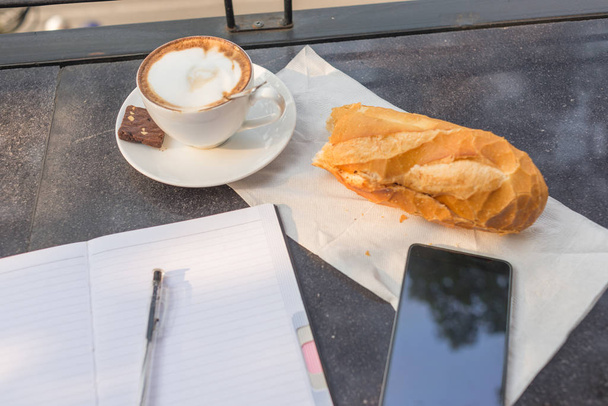 New working day with a cup of coffee and bread - Foto, Imagen