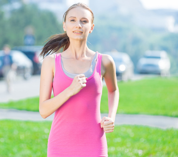 Jogging woman running in city park - Фото, изображение