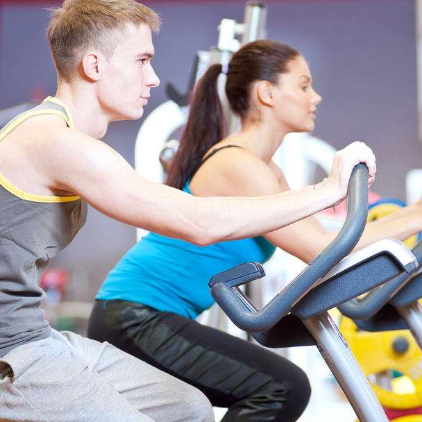 People in the gym doing cardio cycling training - Photo, image