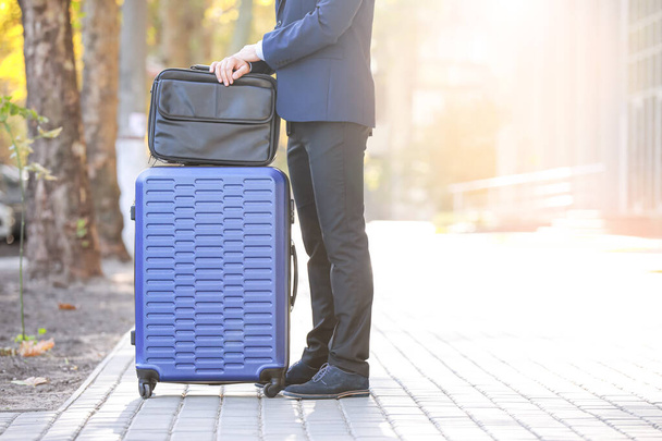 Young man with luggage for business trip outdoors - Foto, afbeelding