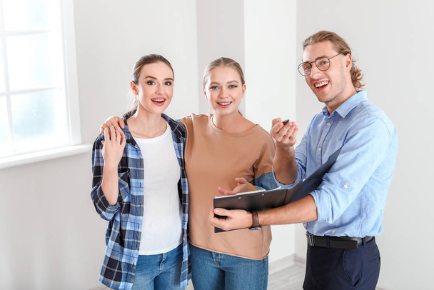 Real estate agent showing lesbian couple a new house - Photo, Image