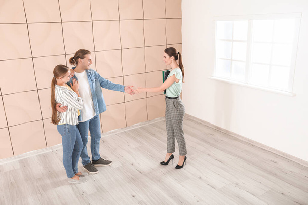 Man shaking hands with real estate agent indoors - Photo, Image