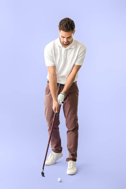 Handsome male golfer on color background - 写真・画像