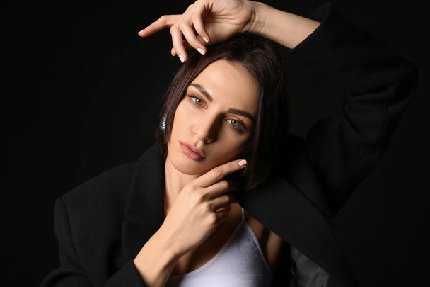 Portrait of fashionable young woman on dark background - Fotoğraf, Görsel