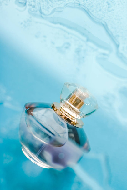Пляшка парфумів під блакитною водою, свіжий морський прибережний аромат, як гламур
 - Фото, зображення