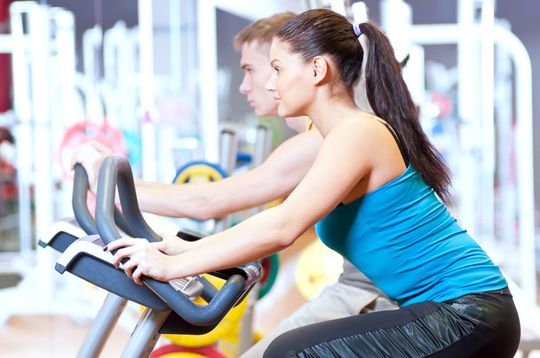 People in the gym doing cardio cycling training - Foto, Imagem