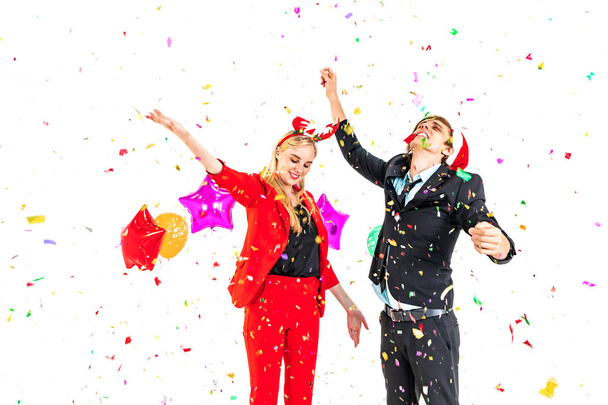 young couple enjoy dance with colorful confetti in new year celebration hangout party - Foto, Bild