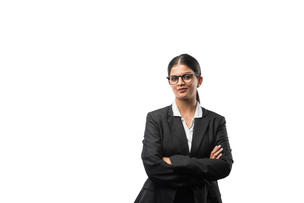 portrait of cheerful indian young business woman in suit, standing against white background - 写真・画像