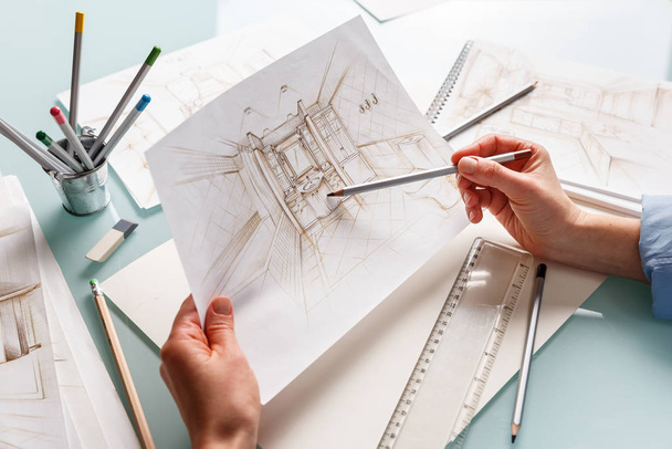 Interior designer holding hand drawing pencil sketch of a bathro - Foto, immagini