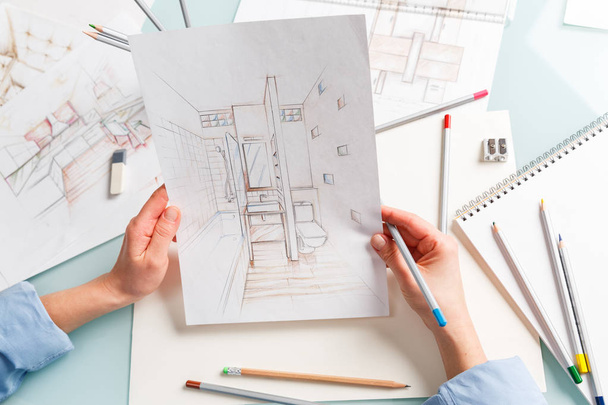 Interior designer holding hand drawing pencil sketch of a bathro - Фото, зображення