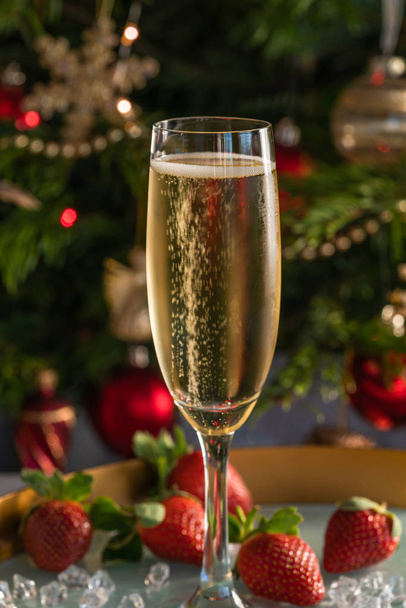 Champagne in glass with strawberries on festive background - Photo, Image