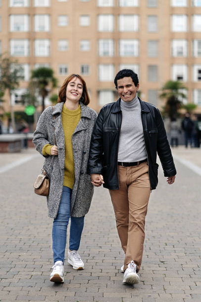Happy couple walking together in the city - Фото, изображение