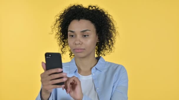 Portrait of Casual African Woman Celebrating Success on Smartphone - Кадры, видео