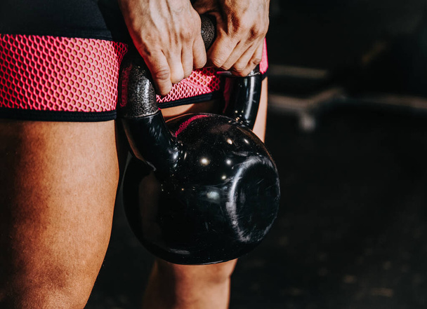 Detail of hands holding a kettlebell in the gym - Foto, imagen
