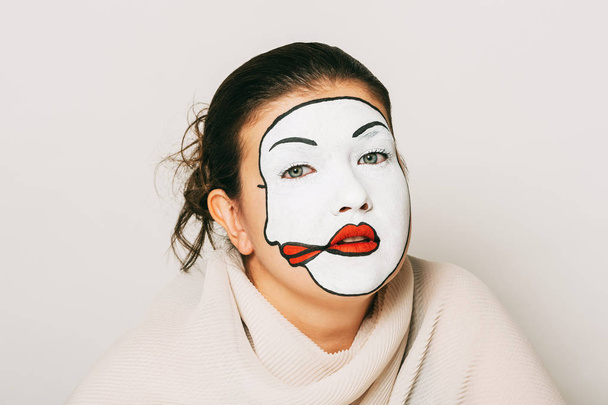 Woman actress with double face makeup studio portrait - 写真・画像