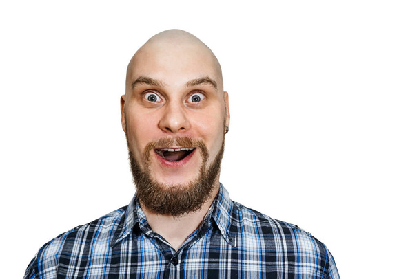 portrait of a surprised bald bearded guy with open mouth and big eyes on a colored background - Foto, Imagem