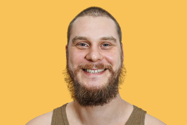 face portrait of laughing happy bearded unshaven guy on isolated background - Fotó, kép