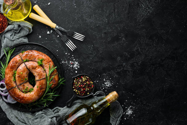 Baked pork sausage with rosemary and spices. Top view. Free copy space. - Foto, Bild