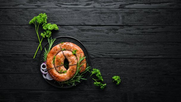 Baked pork sausage with rosemary and spices. Top view. Free copy space. - Fotografie, Obrázek