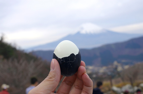 hold black boiled egg with Fuji mountain background, Fuji Hakone - Photo, Image