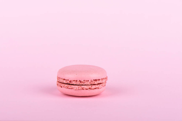 Pink macaroon isolated on a pink background. - Φωτογραφία, εικόνα