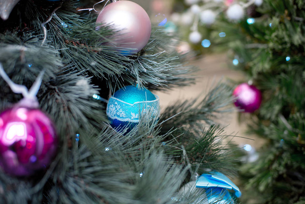 Christmas tree branches balls decoration New Year with bokeh lights on background. - Фото, зображення