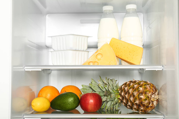Open refrigerator full of different fresh products - 写真・画像