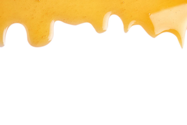 Fresh sweet honey flowing on white background - Valokuva, kuva