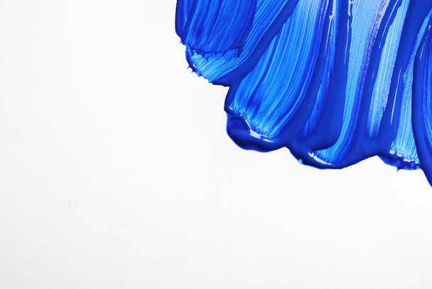 Paint strokes on white background background, top view. Color of the year 2020 (Classic blue) - Foto, afbeelding