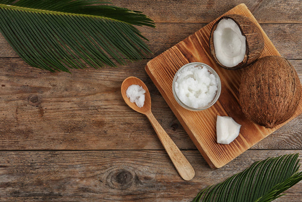 Flat lay composition with coconut oil on wooden table. Cooking i - Foto, Imagen
