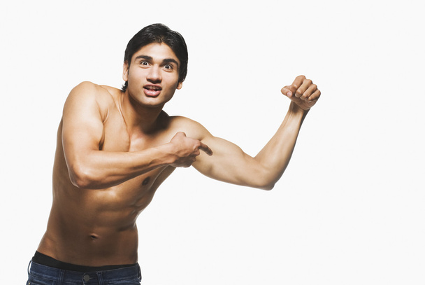 Portrait of a man showing his biceps - Zdjęcie, obraz