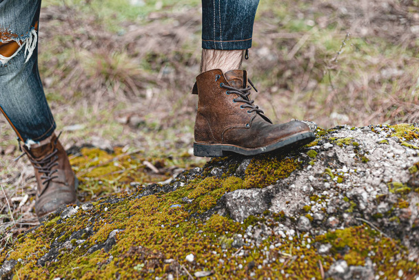 Guy hiking in comfortable hiking boots. Boots close-up stock photo. - Foto, afbeelding