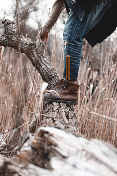 Guy hiking in comfortable hiking boots. Boots close-up stock photo. - 写真・画像