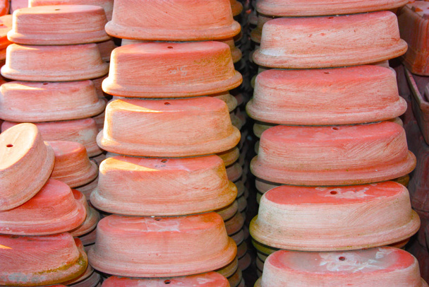 open air workshop of ceramics, earthenware, orange and brown terracotta flower pots - Photo, Image