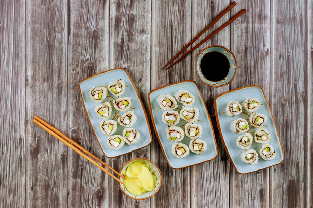 Set of sushi roll with soy sauce, ginger and chopstick. Asian cuisine. - Fotó, kép