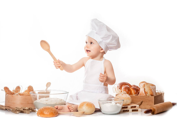 baby kok zit op de tafel brood meel - Foto, afbeelding