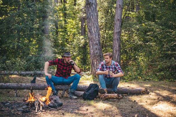 Summer vacation forest. Picnic friends. Friends sit on forest picnic. Young people having a camping. Best friends spend leisure weekend hike barbecue forest nature background. - Foto, Bild