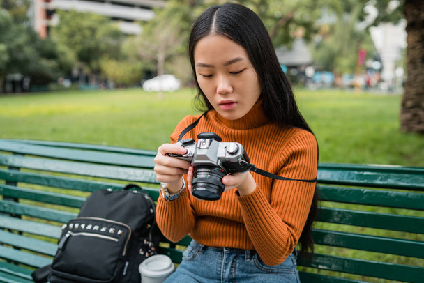 Asian woman using a professional camera. - Photo, image