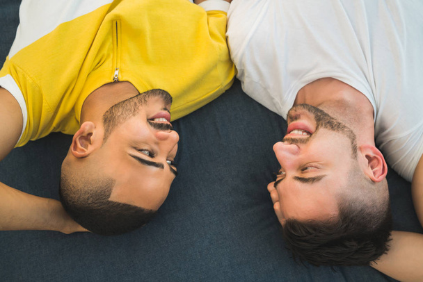 Gay couple laying down on the floor. - Fotografie, Obrázek